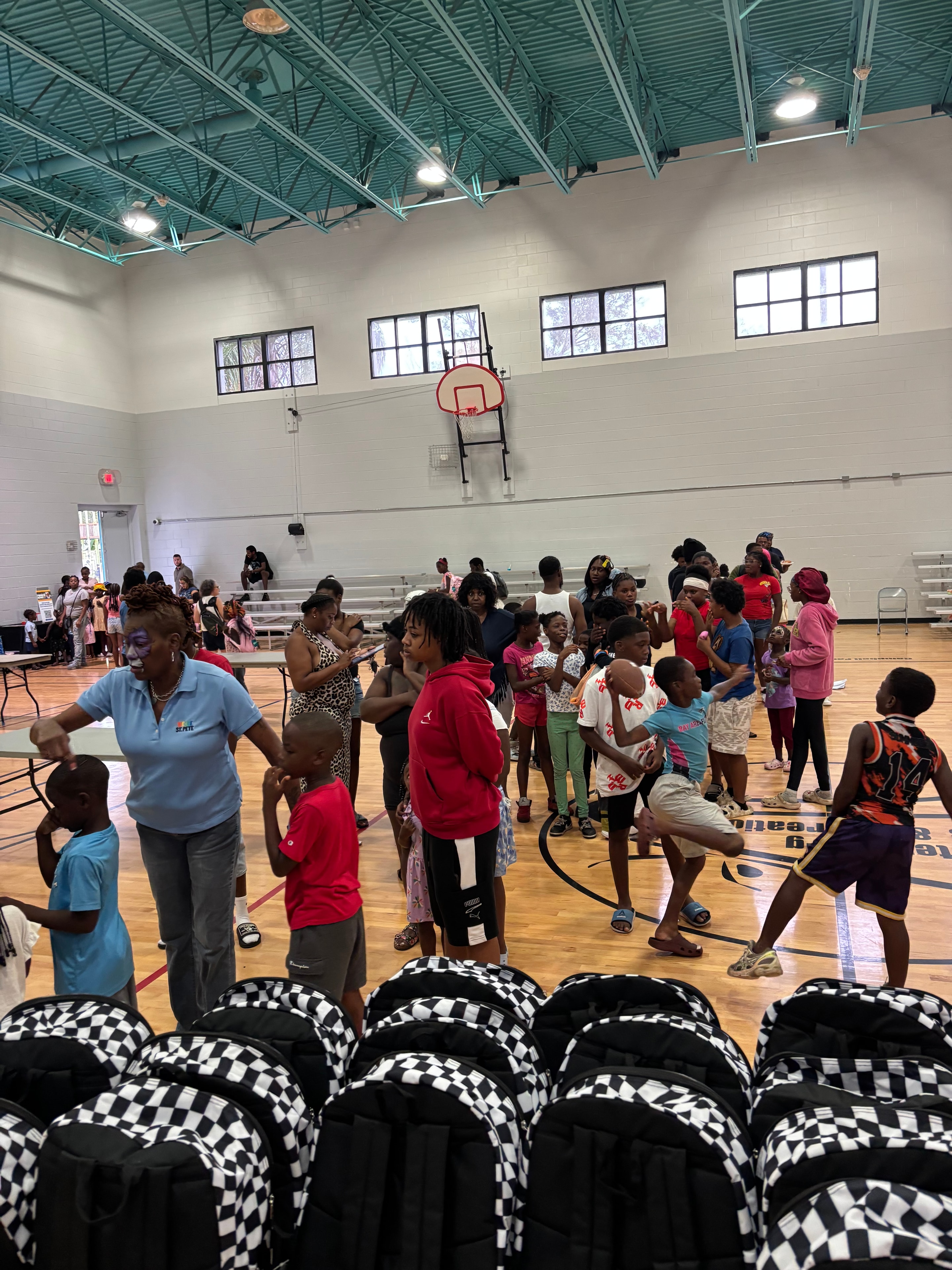 Large crowd of students and families gathered inside Campbell Park Recreation Center for the City of St. Petersburg End of Summer Bash