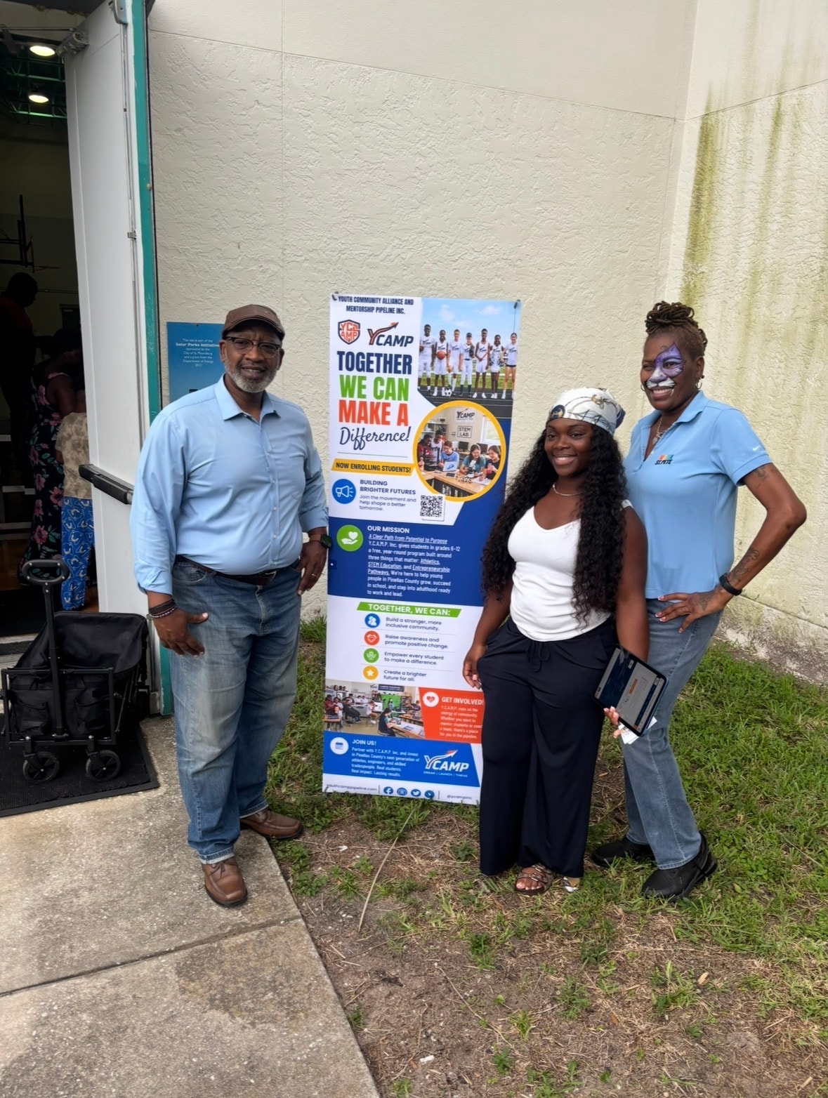 Y.C.A.M.P. founder, Ms. Lisa Wheeler of the City of St. Petersburg, and Mayor Ken Welch together at the End of Summer Bash backpack giveaway at Campbell Park
